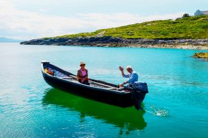 Co Mayo, Ireland, Inishturk Island. Mike O'Toole and his wife, Pauline headding out to Clare Island for the day in the Currach