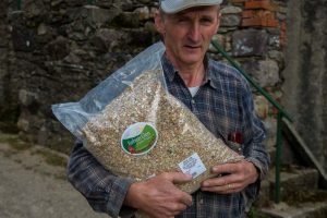Richard Murphy, Glen Organic Farm, Glenmore, County Kilkenny, Ireland, with rolled Corn animal feed.